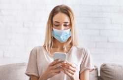 Girl reads news at smartphone about coronavirus quarantined